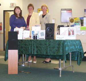 Darcy, Jan and Georgia behind Meadowlark Audio Display